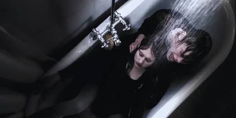 Tate Langdon (played by Evan Peters) crying and holding a lifeless Violet Harmon (played by Taissa Farmiga) in the shower in American Horror Story: Murder House