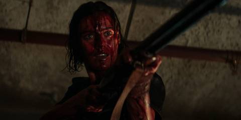 Beth with a shotgun in Evil Dead Rise