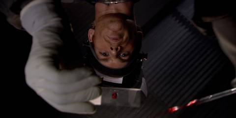 Dexter Morgan putting a drop of blood on a slide in Dexter season 1, episode 1