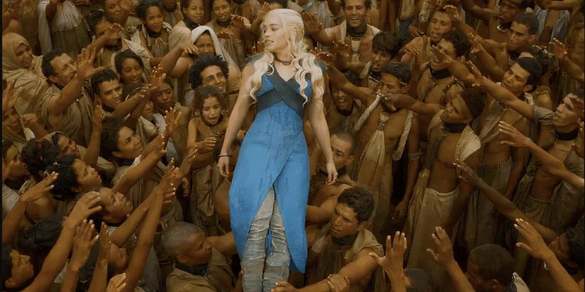 Daenerys (Emilia Clarke) in blue, held aloft by the people of Yunkai in Game of Thrones season 3, episode 10