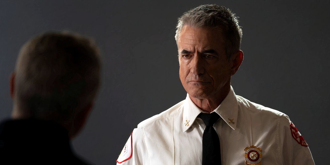 Dermot Mulroney as Dom Pascal in Chicago Fire, in uniform and tie and talking to someone