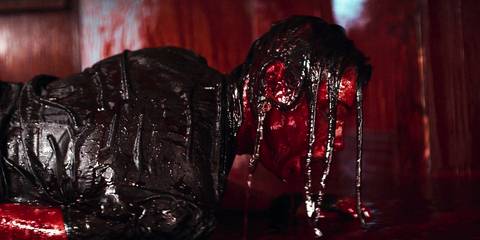 Evil Dead Rise Beth covered in blood gasping for air