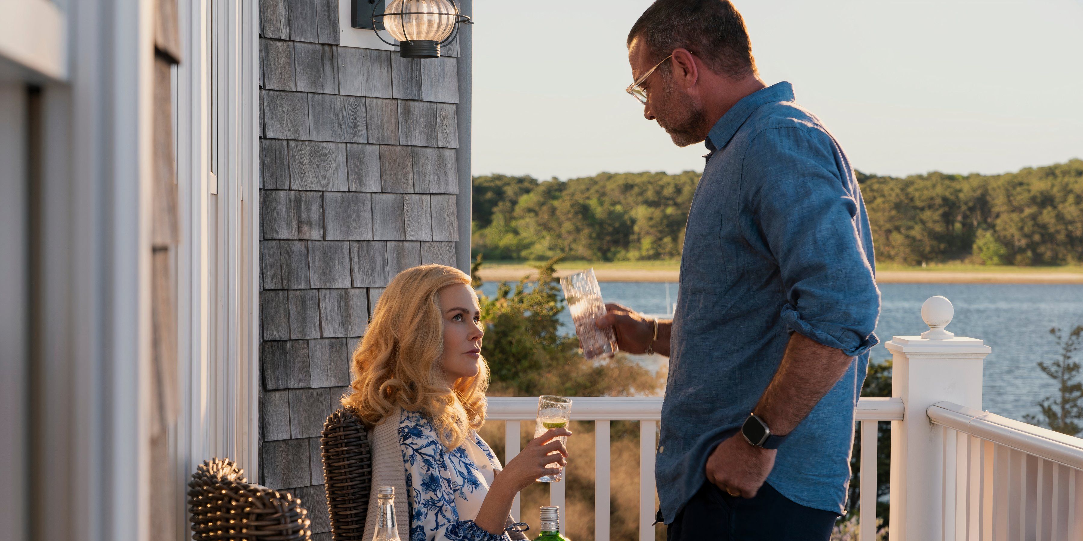 Greer and Tag cheers on the porch in The Perfect Couple episode 2-1