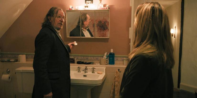 Jackson Lamb (Gary Oldman) speaks with Emma Flyte at the scene of River's apparent murder in Slow Horses season 4, ep 1