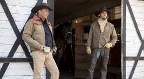 John (Kevin Costner) and Kayce (Luke Grimes) standing outside a barn in Yellowstone