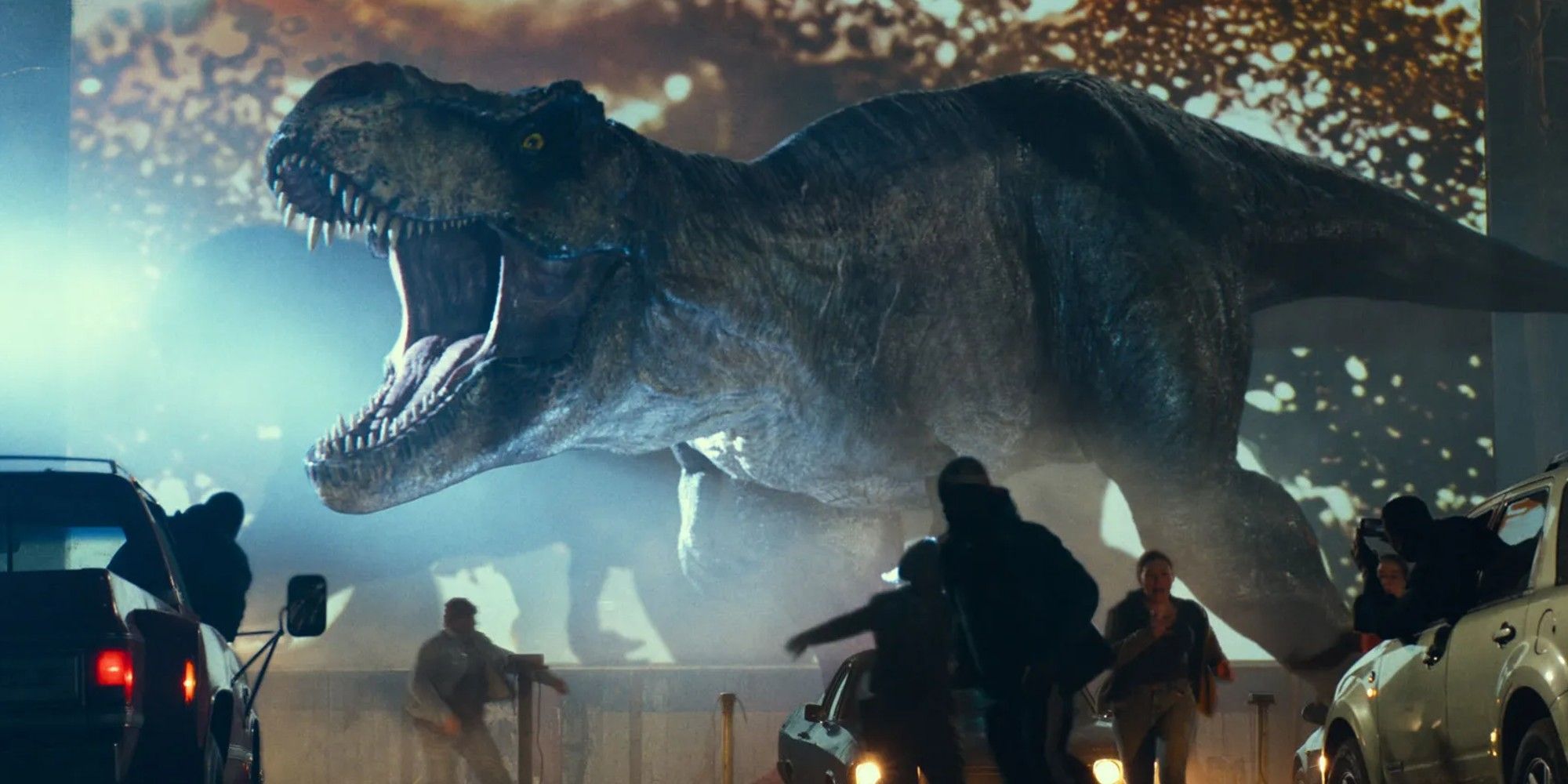 Tyranasaurus Rex reaping havoc at a drive in theater in Jurassic World Dominion