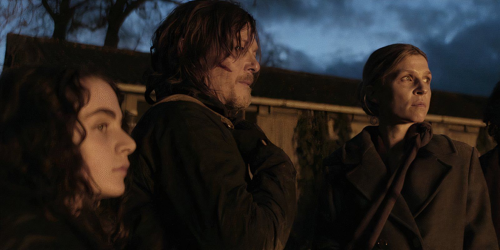 Laurent (Louis Puech Scigliuzzi), Daryl (Norman Reedus), and Isabelle (Clémence Poésy) standing at night in The Walking Dead: Daryl Dixon