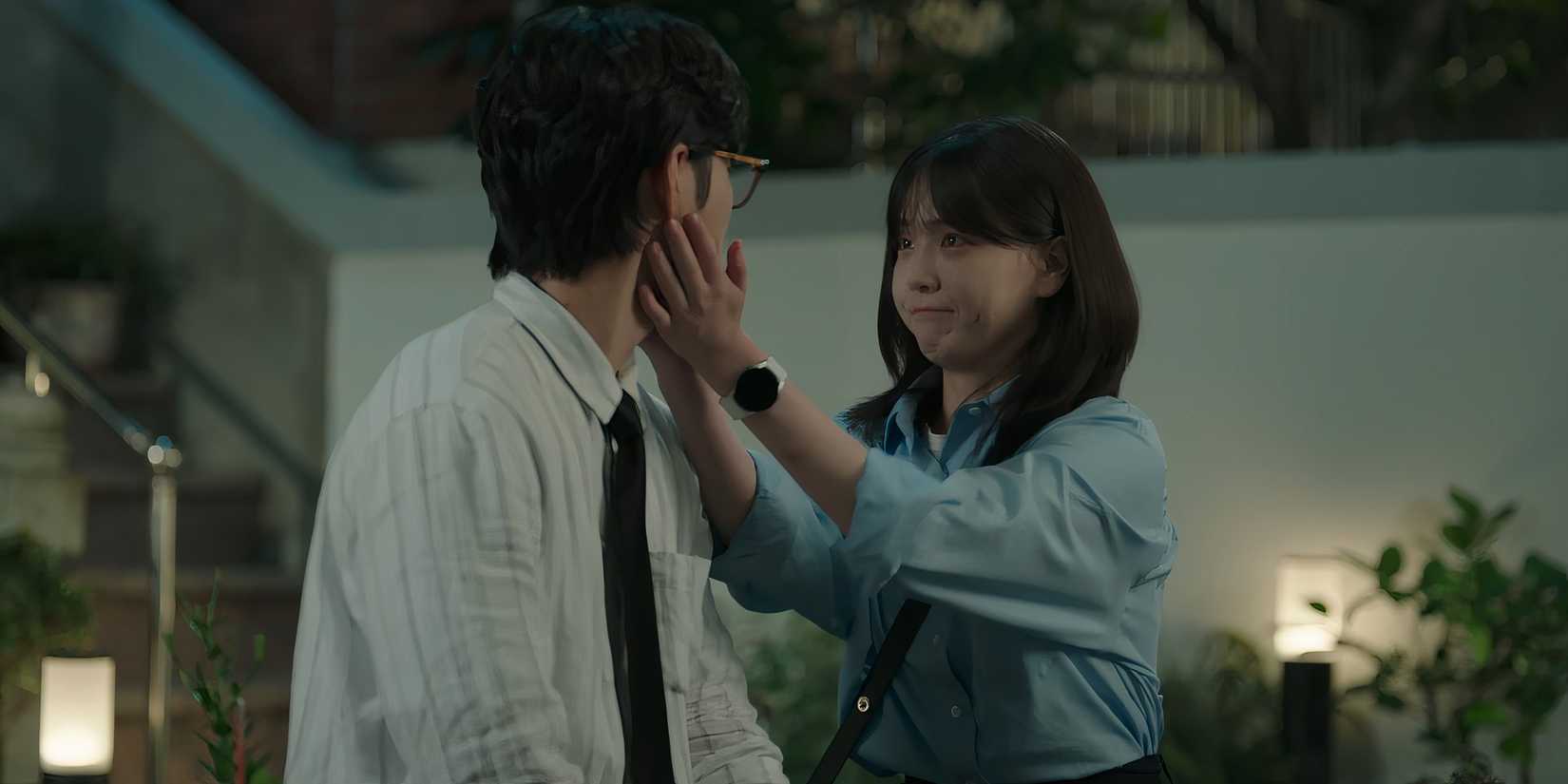 Jung Mo-eum holds her hands to Kang Dan-ho's face in Love Next Door