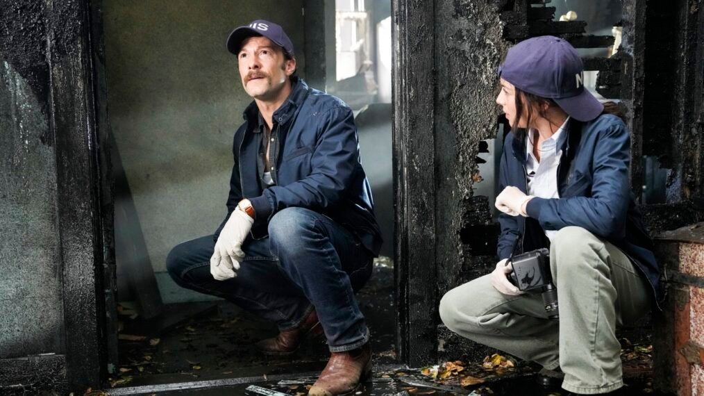 Mike Franks and Lala crouch down at a crime scene in NCIS Origins