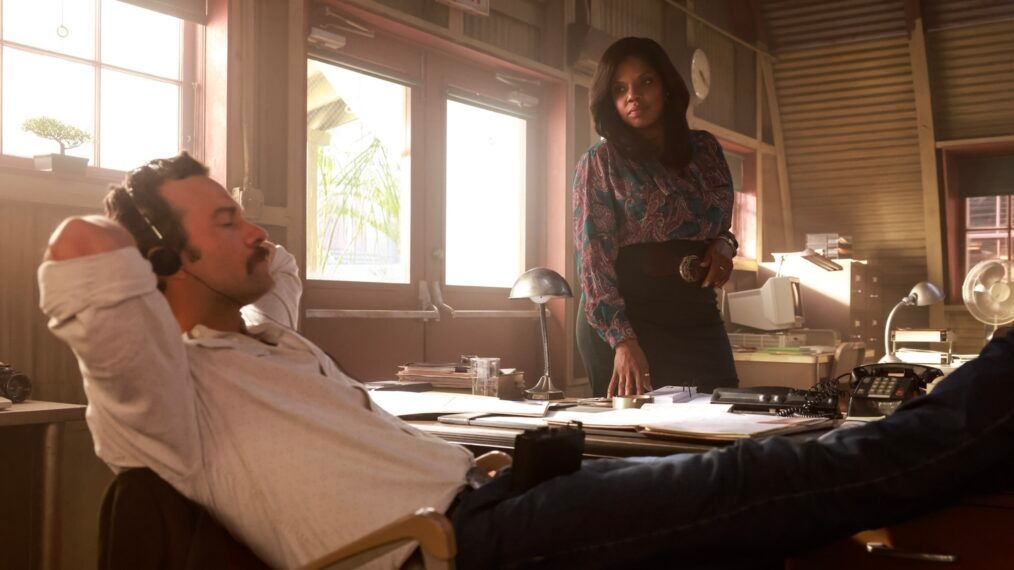 Mike Franks (Kyle Schmid) leans back in a chair with his eyes closed while Mary Jo Hayes (Tyla Abercrumbie) looks on in NCIS Origins