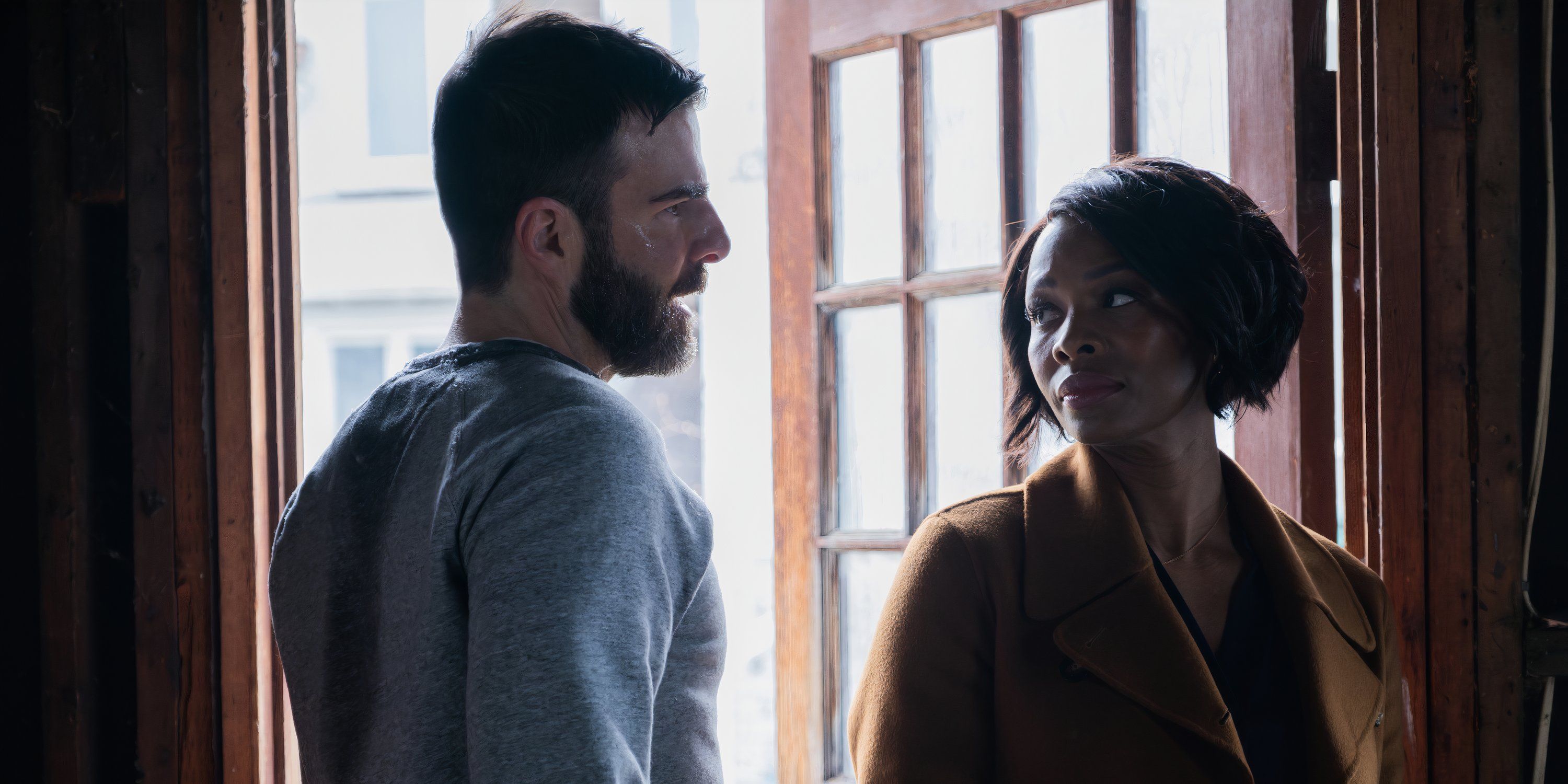 In the pilot of Brilliant Minds, Dr. Zachary Quinto as Oliver Wolf and Dr. Tamber and Perry as Carol Piers look at each other.