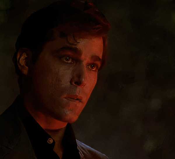Ray Liotta illuminated by red light in the opening scene of Goodfellas