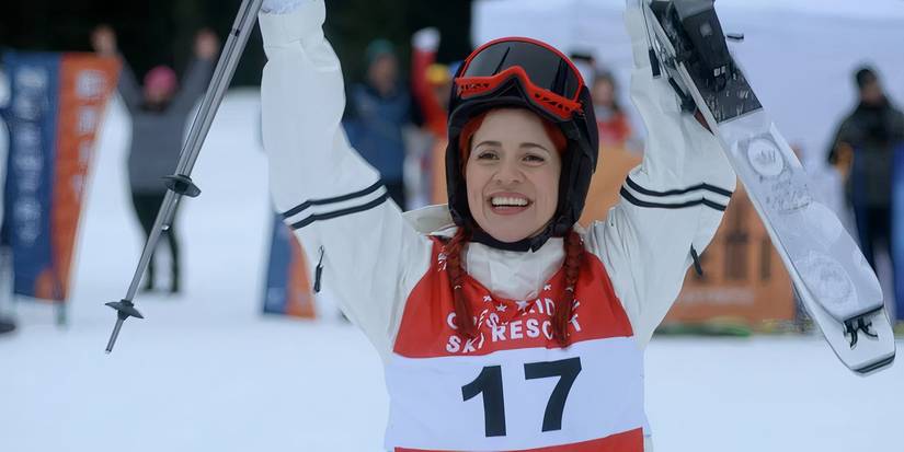 Resident Alien character D'Arcy celebrating a skiing win