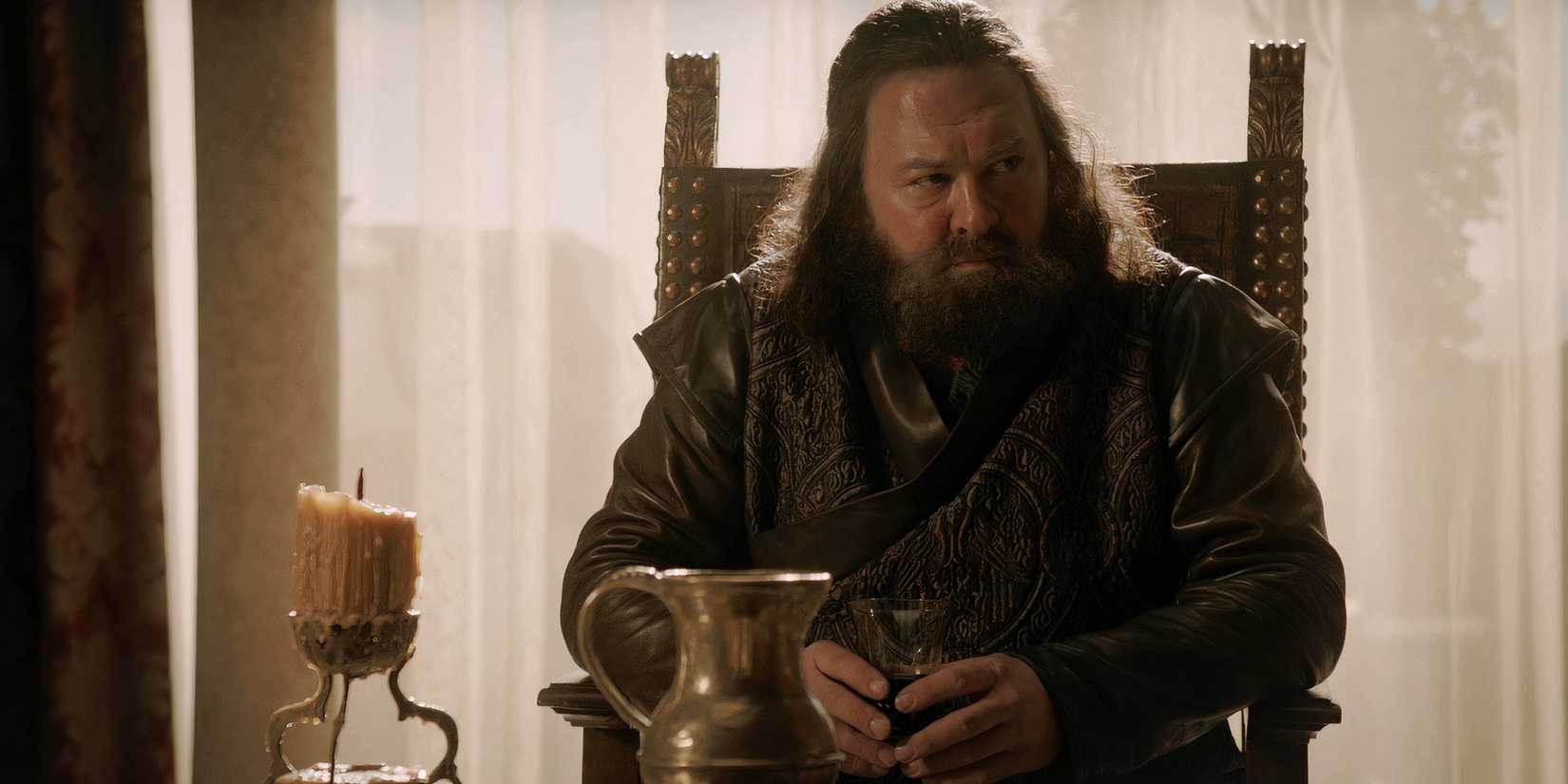 robert baratheon mark addy sitting holding a cup of wine in game of thrones season 1 episode 5