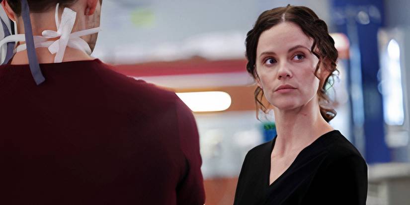 Lenox (Sarah Ramos) looking off to the side while talking to a masked doctor in the Chicago Med season 10 premiere