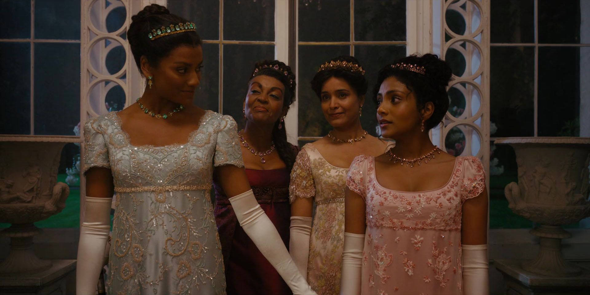 Kate (Simone Ashley) Reassuring Edwina (Charithra Chandran) At The First Ball Of The Season As Lady Mary Sharma (Shelley Conn) & Lady Danbury (Adjoa Andoh) Look On In Bridgerton Season 2, Episode 1, 