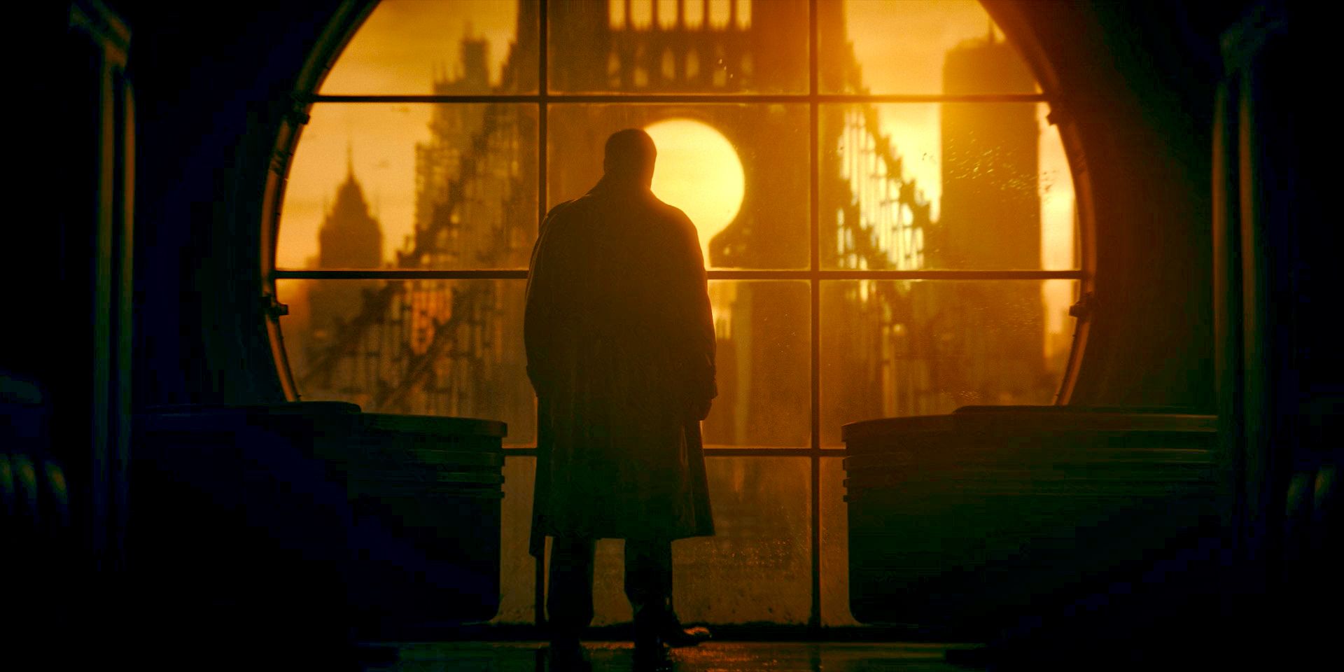 Oz Cobb/The Penguin (Colin Farrell) looking out his window at the chaotic Gotham City in The Penguin Season 1 Episode 1