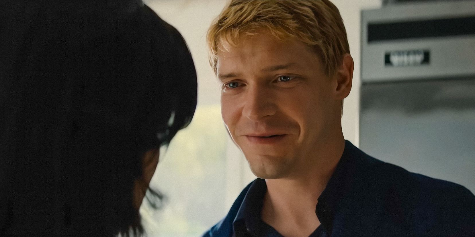 Benji Winbury (Billy Howle) smiling at his girlfriend in The Perfect Couple