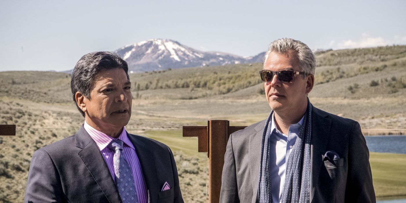 Thomas Rainwater (Gil Birmingham) and Dan Jenkins (Danny Huston) talking in front of a field in Yellowstone