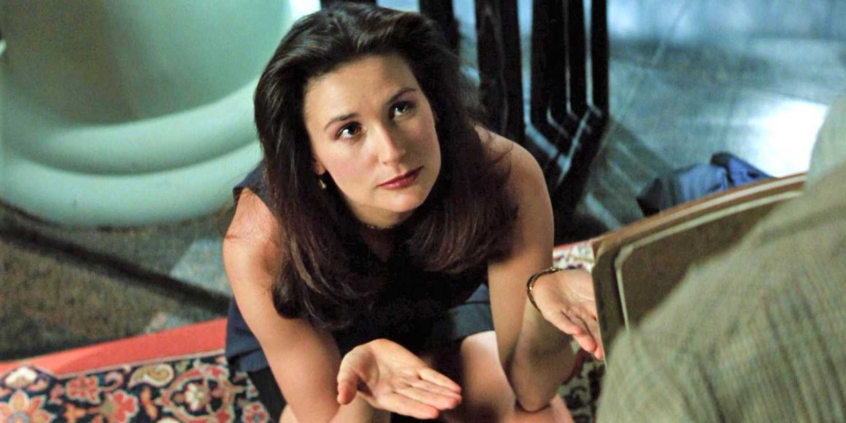 Demi Moore in Disclosure looking off-screen with her hands up