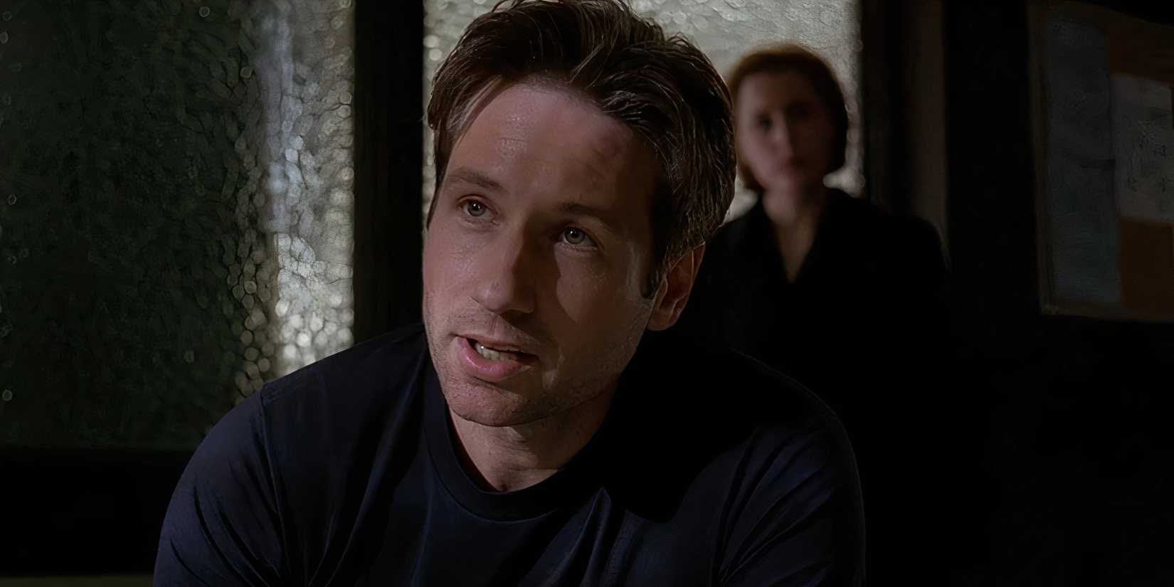 Mulder (David Duchovny) interviews the priest in The X-Files All Souls Mulder