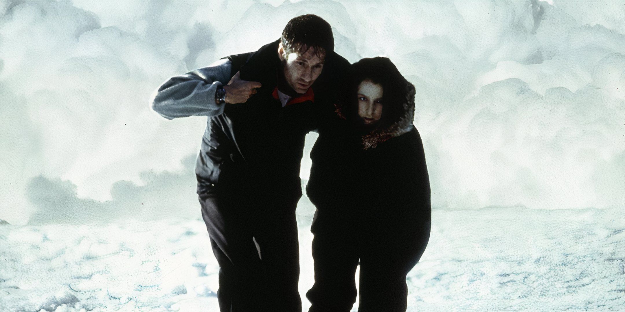 Mulder helps an injured Scully across the ice in The X-Files: Fight the Future.