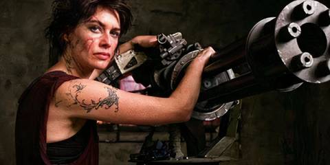 Lena Headey as Ma Ma in Dredd (2012) leaning on a gun