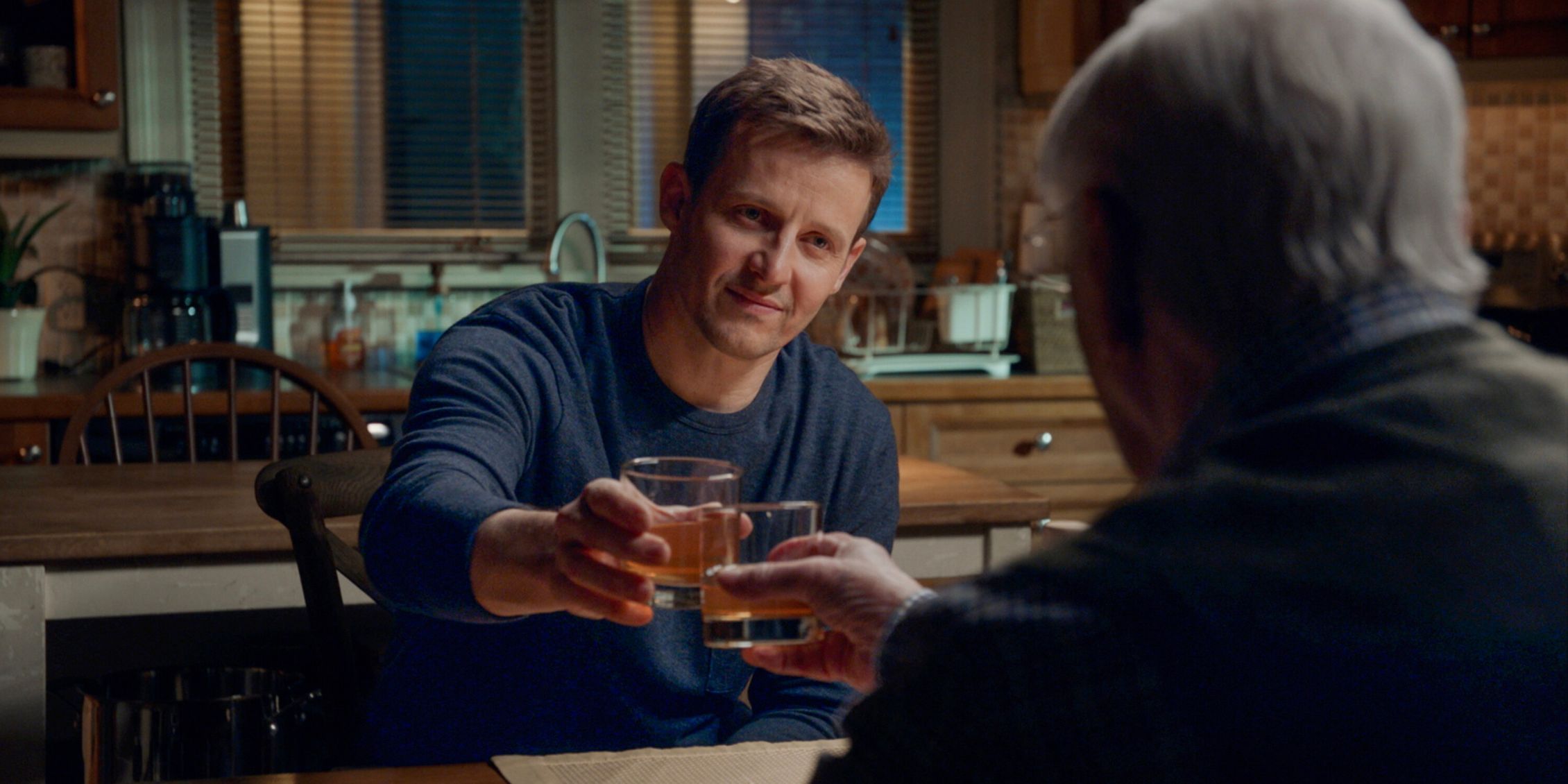 Blue Bloods Jamie clinking glasses with Henry who is seen from the back