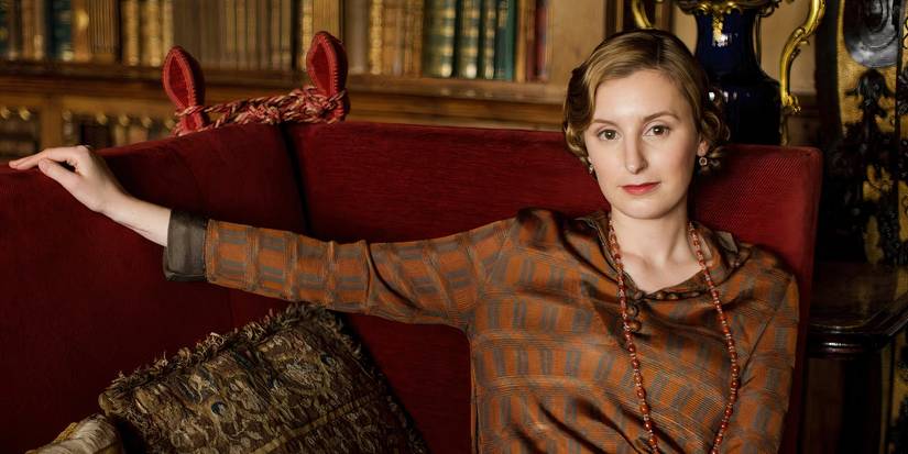 Downton Abbey's Edith is sitting on a couch
