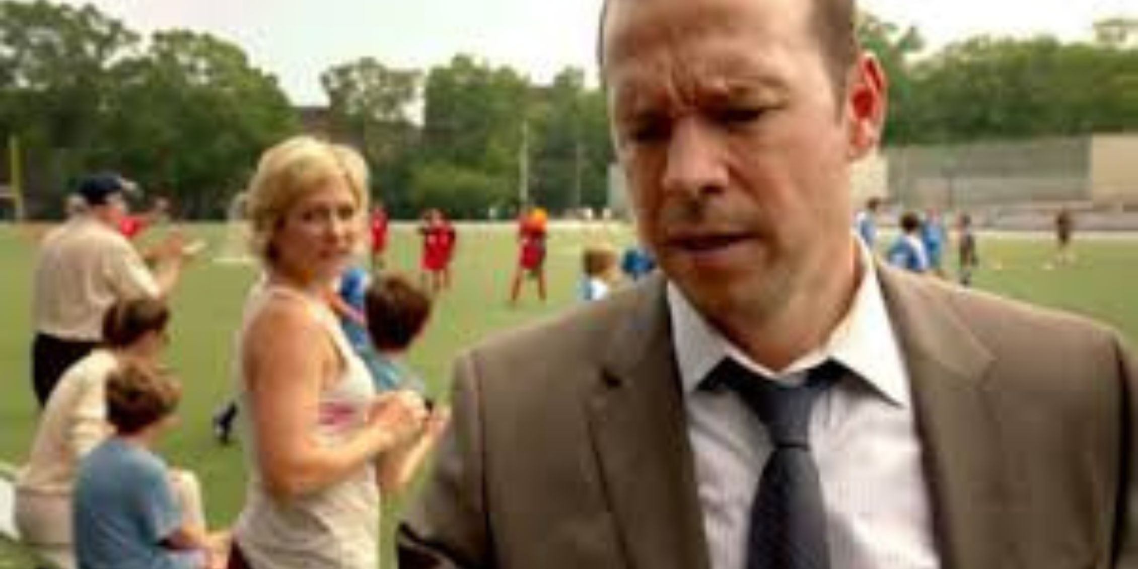 Blue Bloods Linda and the boys notice Danny standing in his suit and tie at a football game