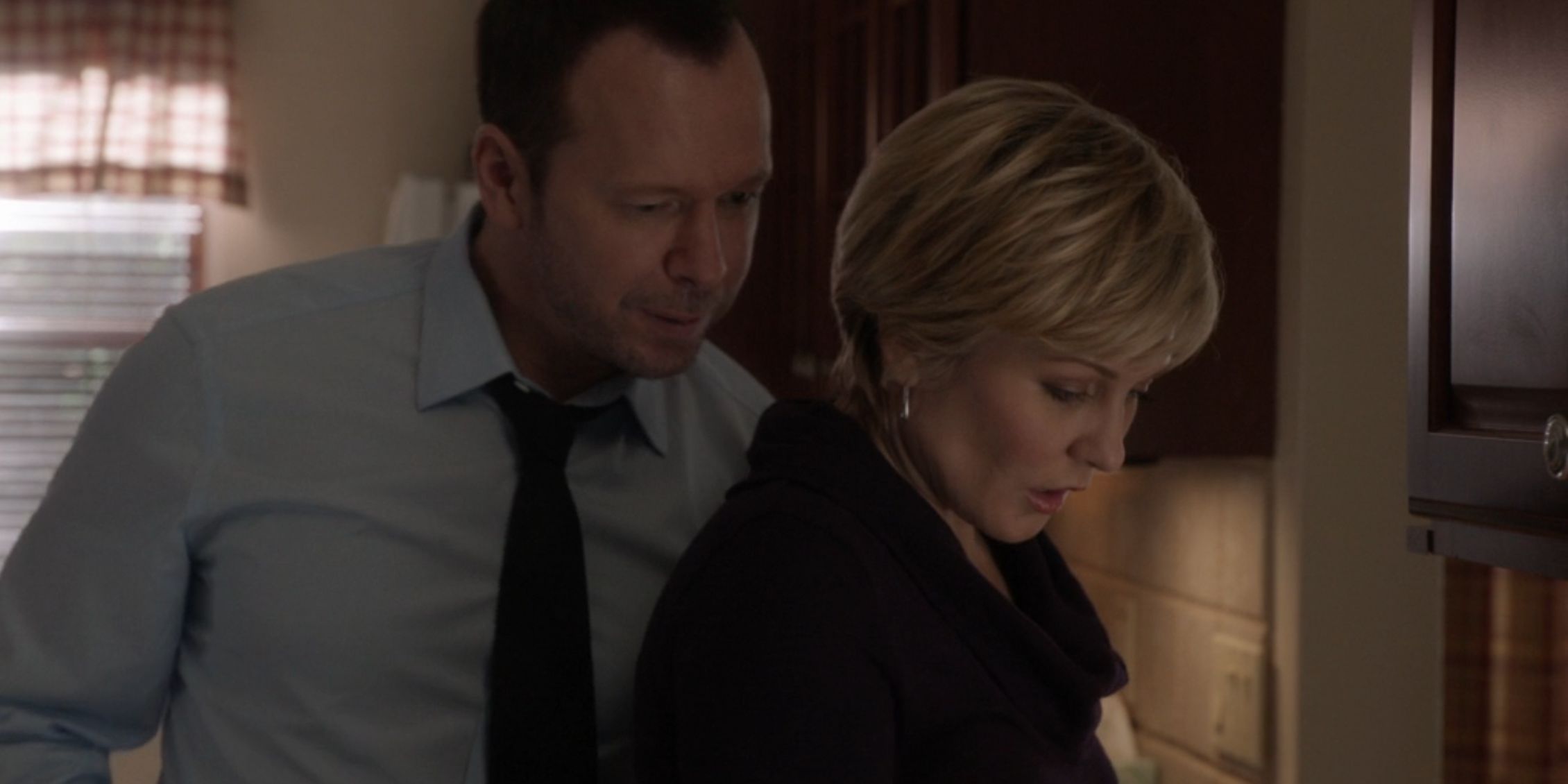 Blue Bloods Danny looks over Linda's shoulder