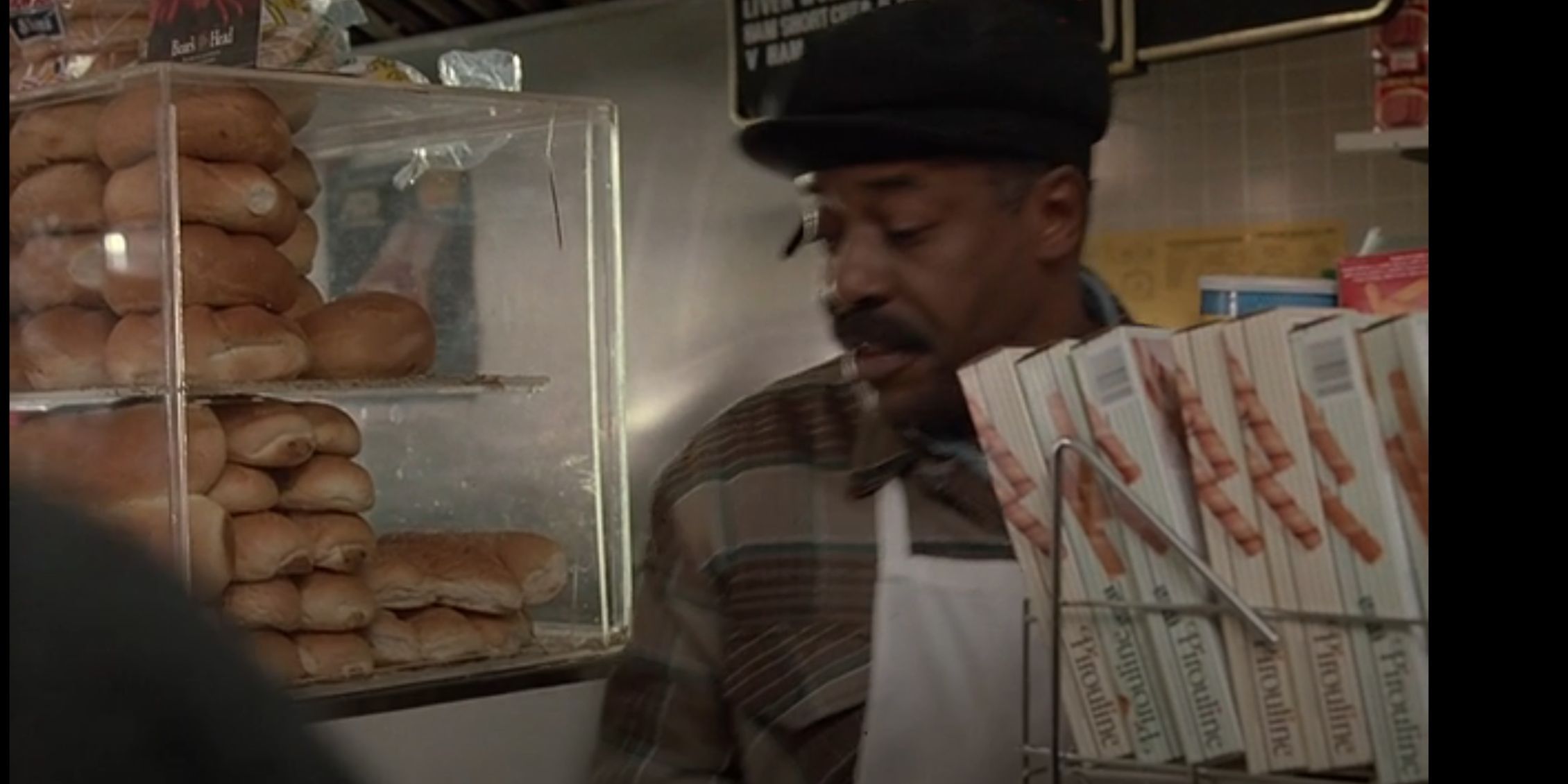 Law & Order David standing behind a counter answering a question