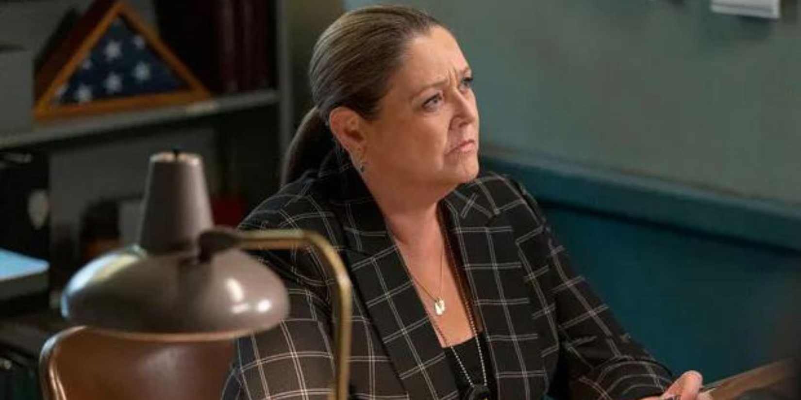 Kate Dixon (Camryn Manheim) at her desk with a lamp on nearby in Law & Order