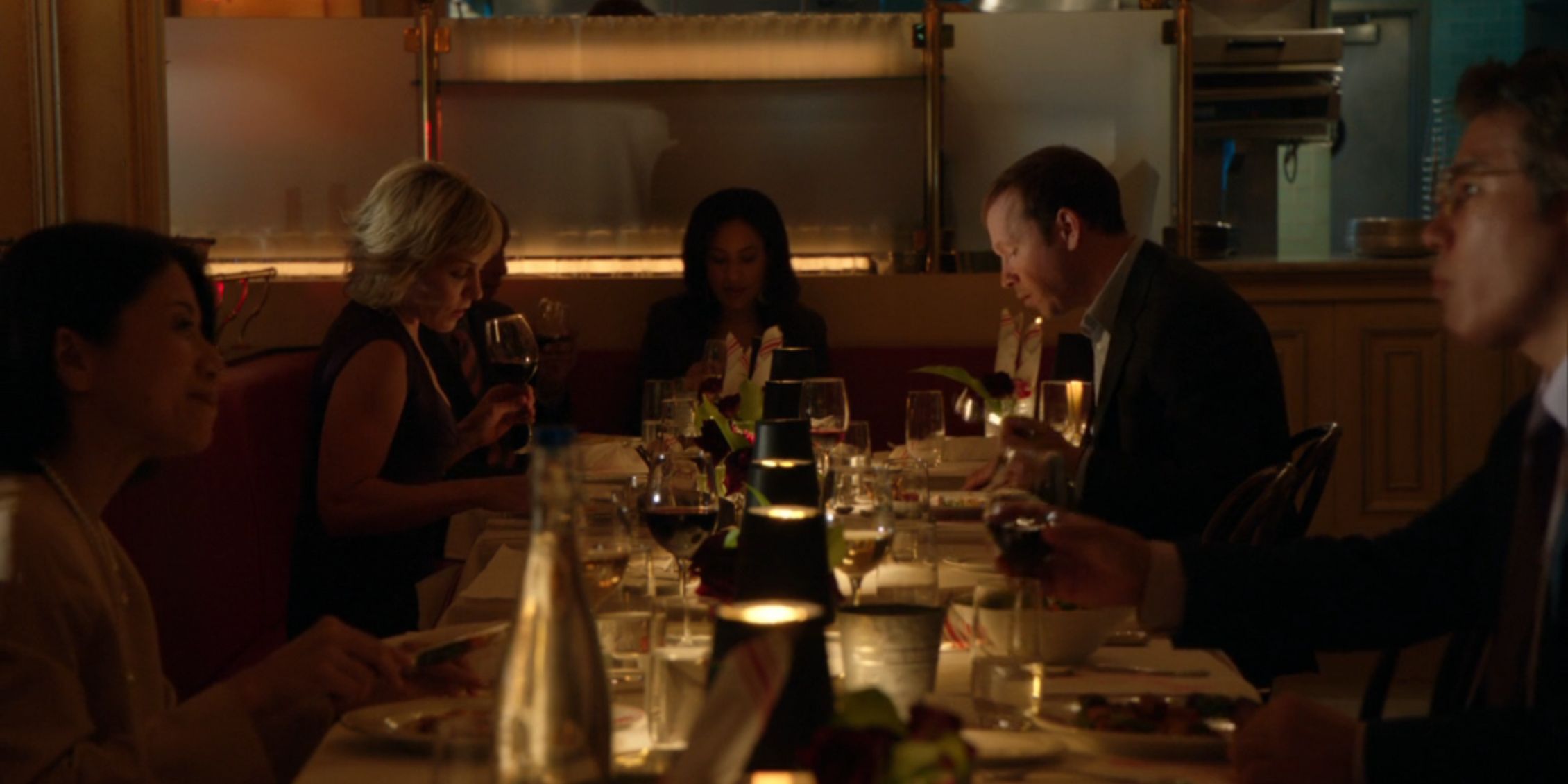 Blue Bloods long shot of Danny and Linda at dinner in a restaurant with a bunch of people