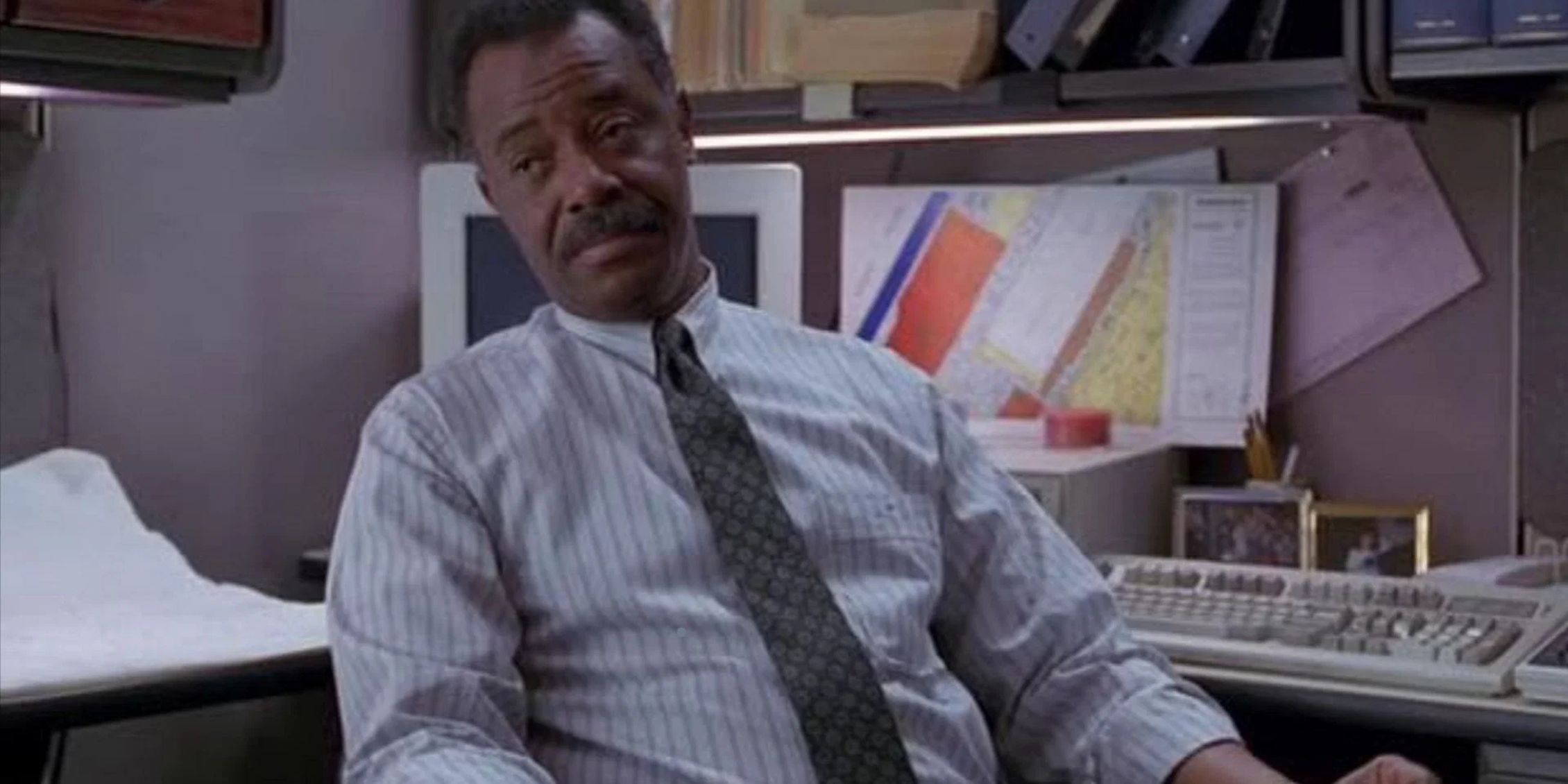 Carl Dunston sitting behind his desk in Law & Order