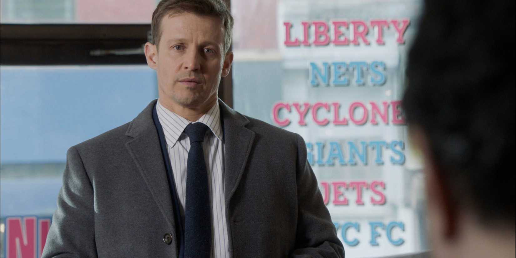 Blue Bloods Jamie in a suit and tie in the office of a gambling place