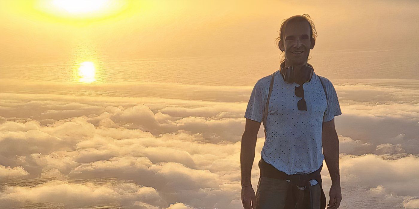 Davide Morosi in Below Deck Sailing Yacht posing on a mountaintop at sunset