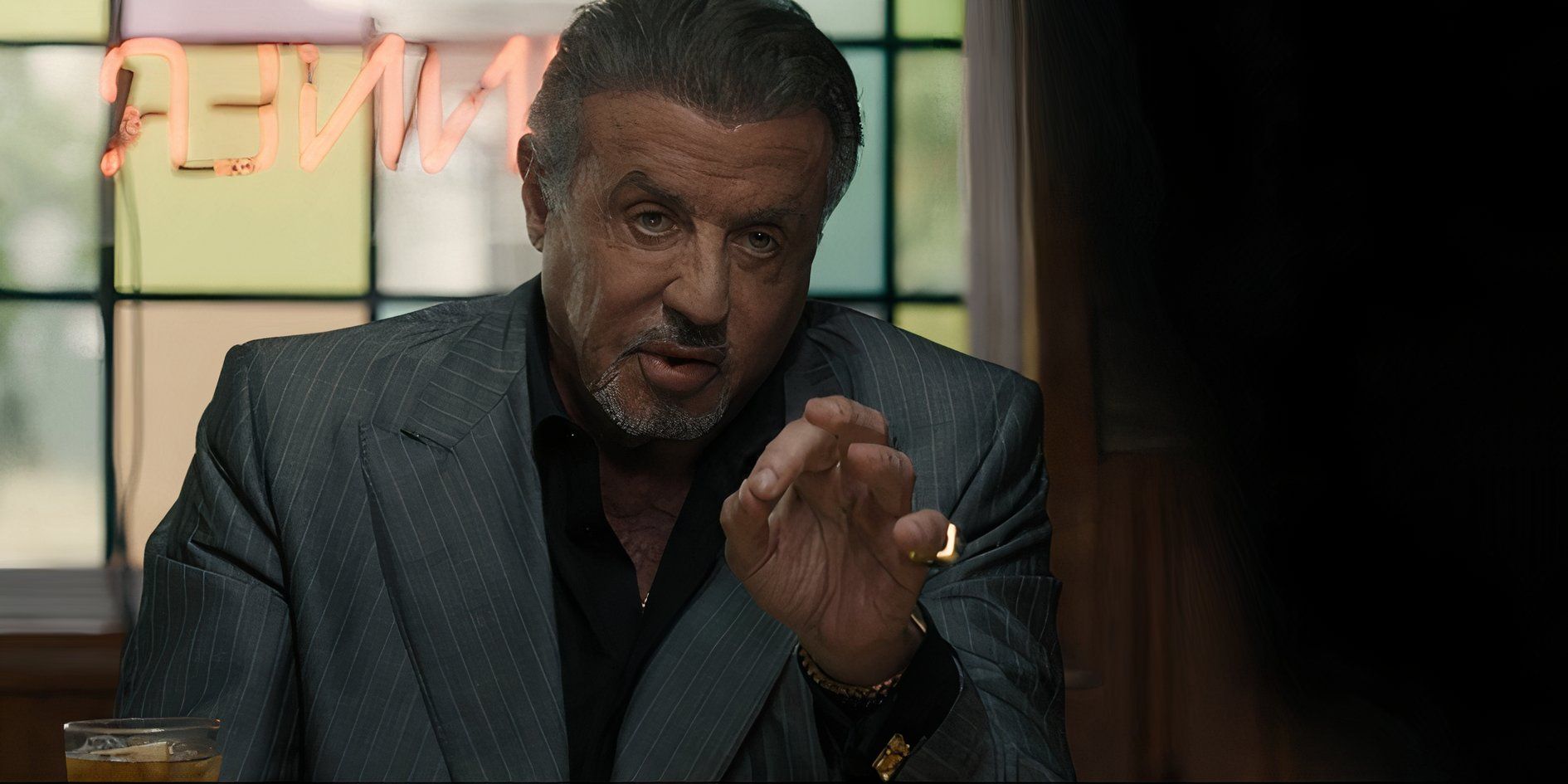 Dwight Manfredi (Sylvester Stallone) holding out his hand while talking in Tulsa King season 2, episode 6