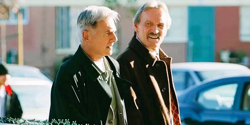 Gibbs and Franks walk together beside some foliage in NCIS