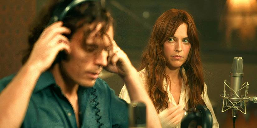 Riley Keough and Sam Claflin putting in their headpieces for a recording session in Daisy Jones and the Six