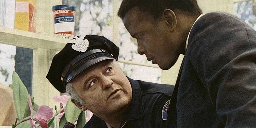 Sidney Poitier’s Tibbs stares at a cop, who stares back in the film In the Heat of the Night.