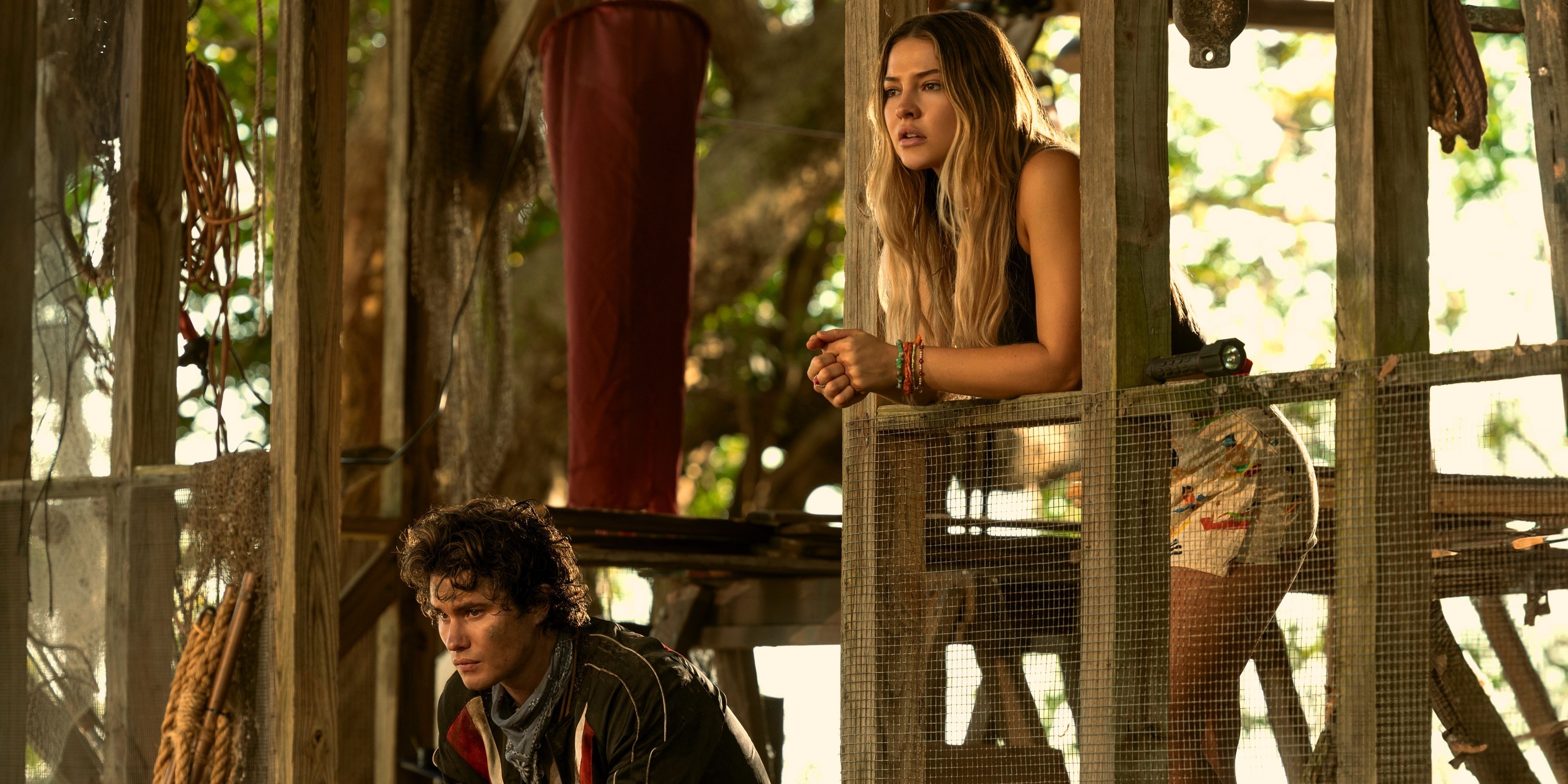 John B sitting down while Sarah looks over a ledge in Outer Banks season 4