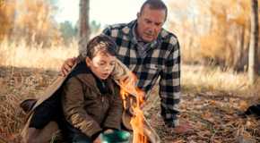 John (Kevin Costner) helping Tate (Brecken Merrill) making a fire in the woods in Yellowstone