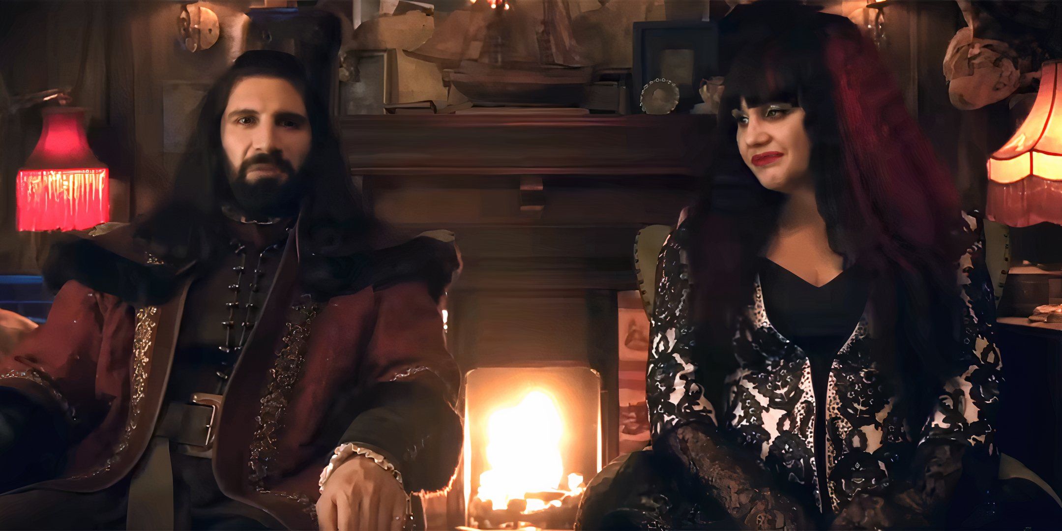 Kayvan Novak's Nandor and Natasia Demetriou's Nadja sit next to each other and talk to the camera in What We Do in the Shadows Season 6