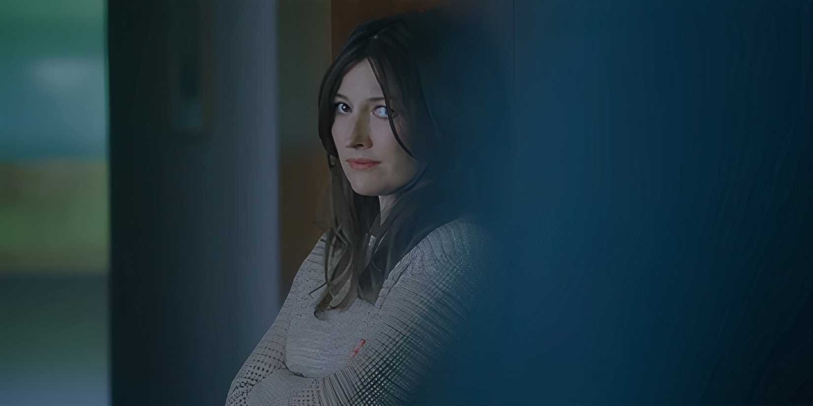 Kelly Macdonald as Helen leaning against a cabinet and smiling subtly in The Radleys