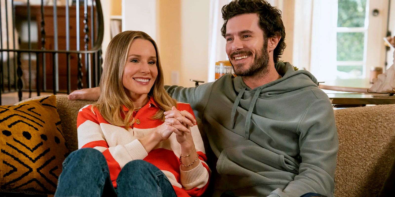 Kristen Bell and Adam Brody sitting on a couch in Nobody Wants This