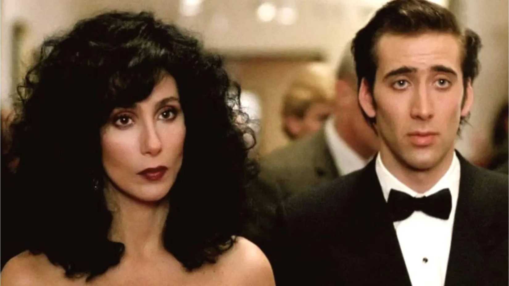 Cher and Nic Cage look on in fancy dress in Moonstruck