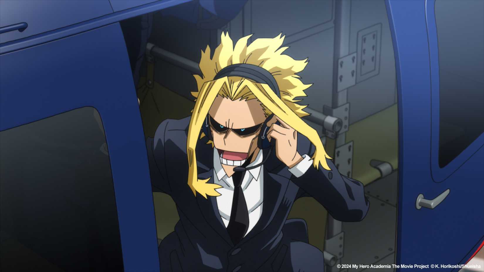 My Hero Academia You're Next, All Might, skinny, in a helicopter, speaking into a microphone.