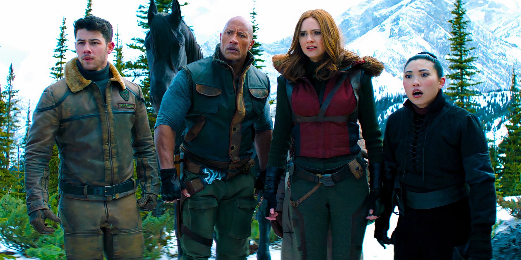 Nick Jonas, Dwayne Johnson, Karen Gillan and Awkwafina all looking serious and concerned at something in Jumanji The Next Level