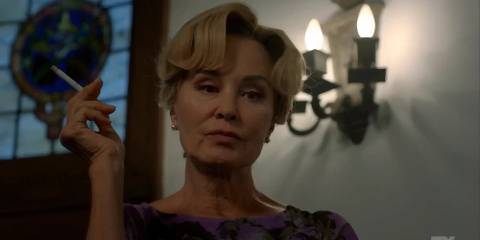 Constance returns to American Horror Story Apocalypse by walking down the stairs and holding a cigarette.